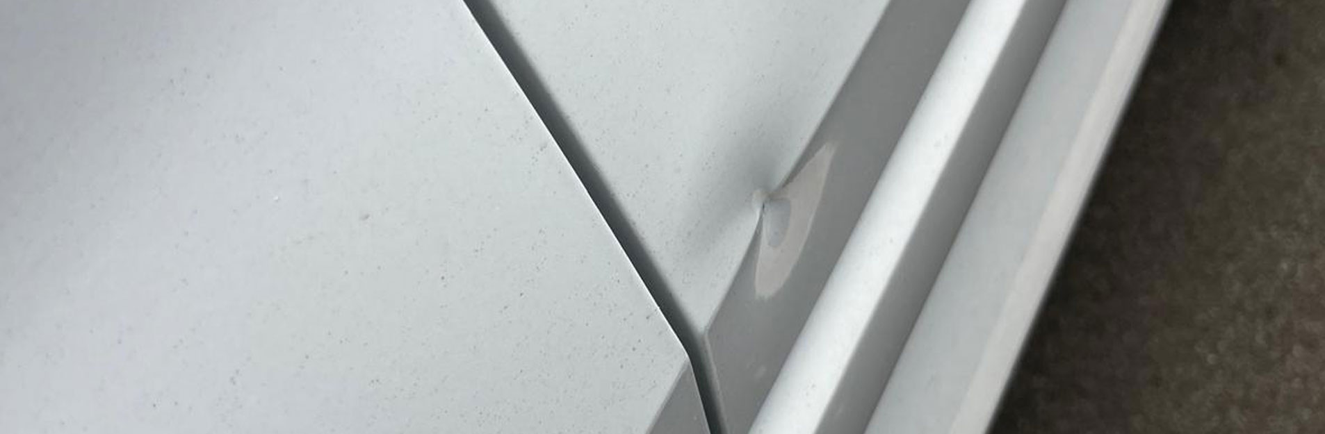 An image of a dent on the back of a car.