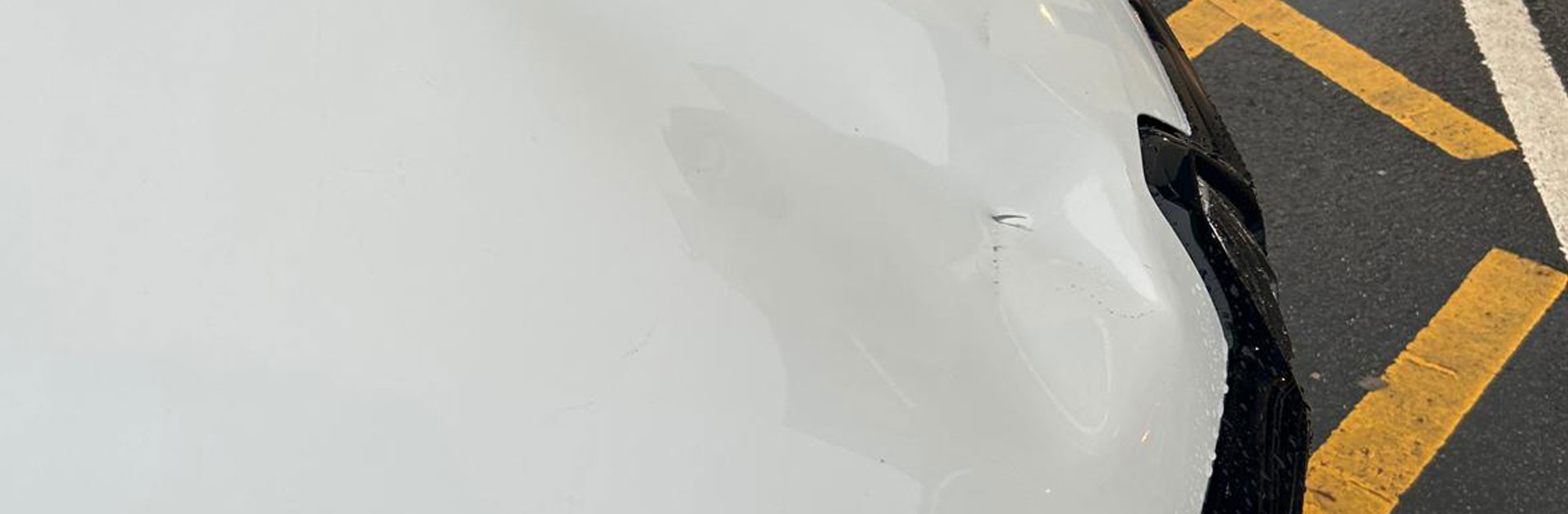 An image of a dent in a car bonnet.