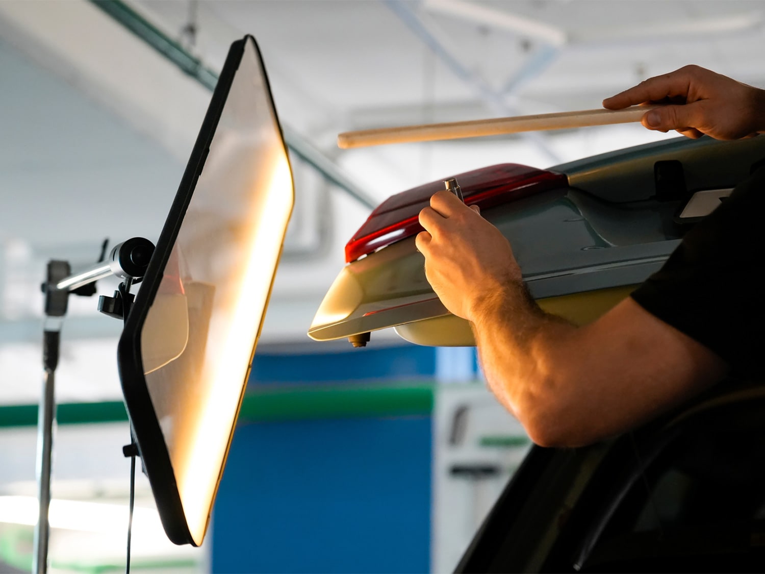 An image of a dent being mended on a car.