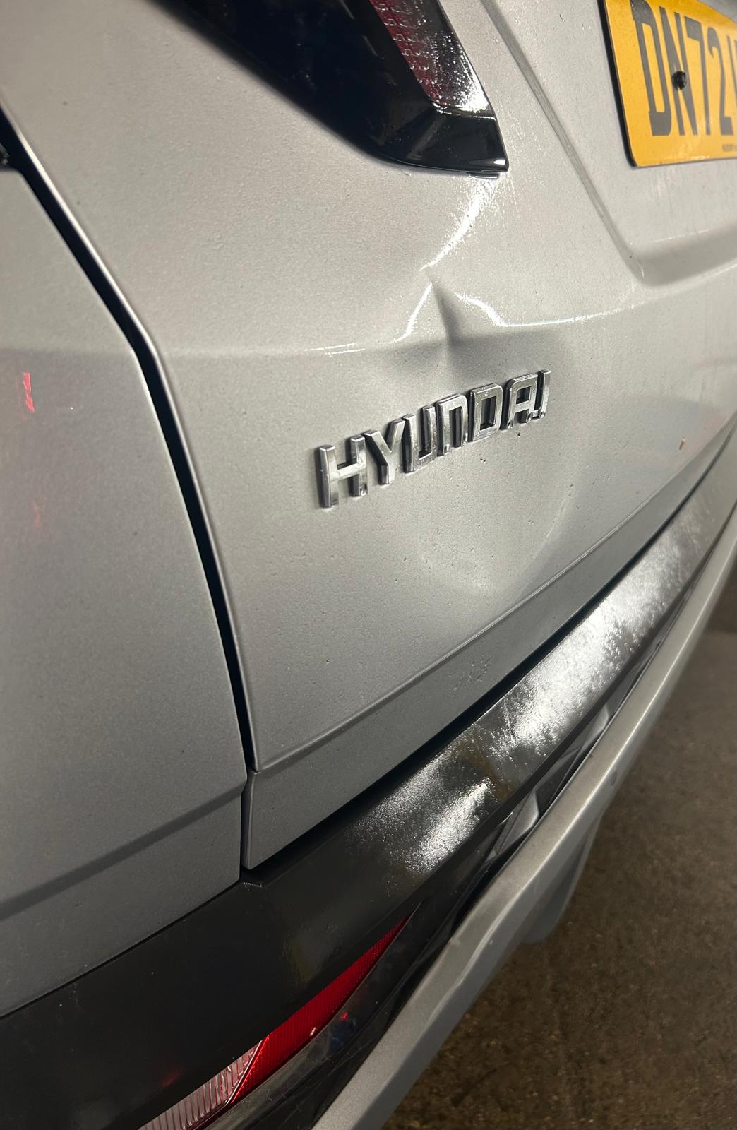 A dent in a silver Hyundai.