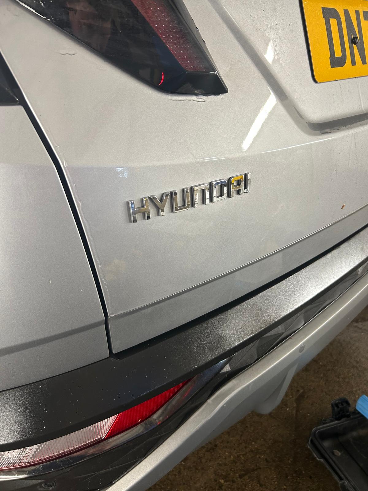 The dent on the silver Hyundai is fixed.
