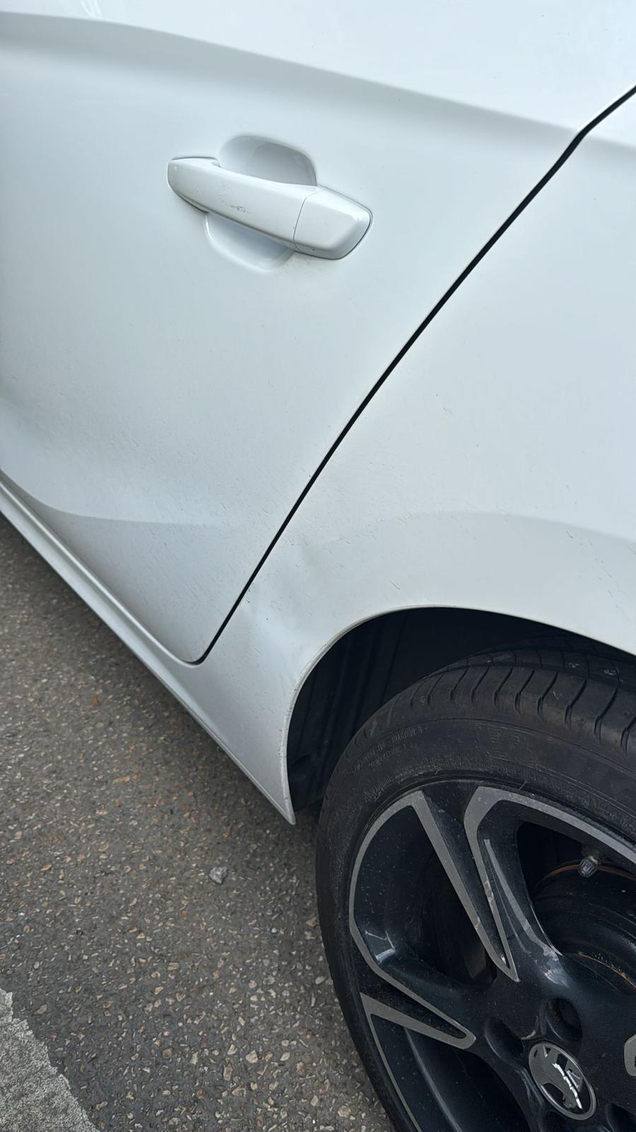 A dent in a silver Vauxhall.