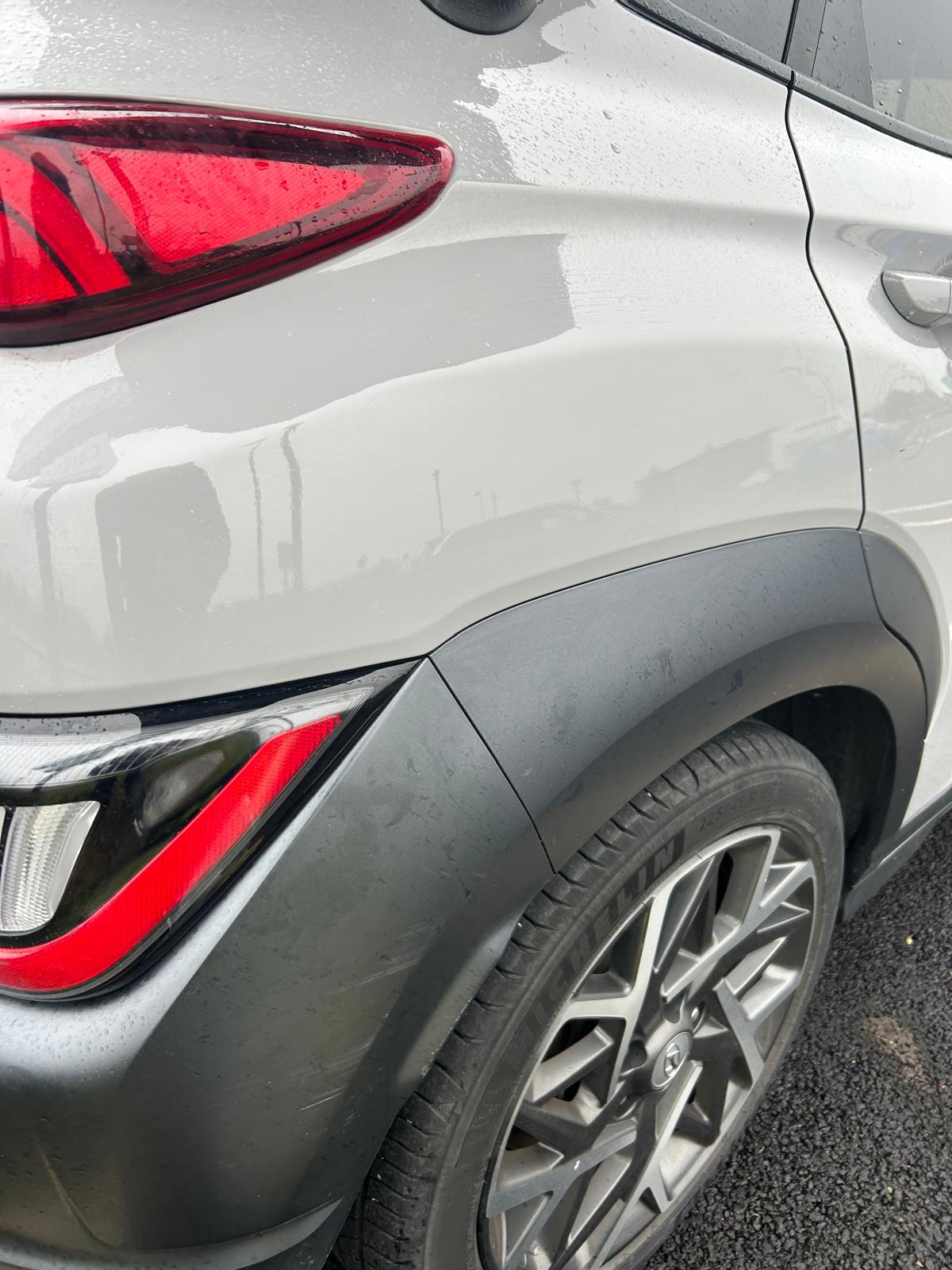 The dent on the white Hyundai is fixed.