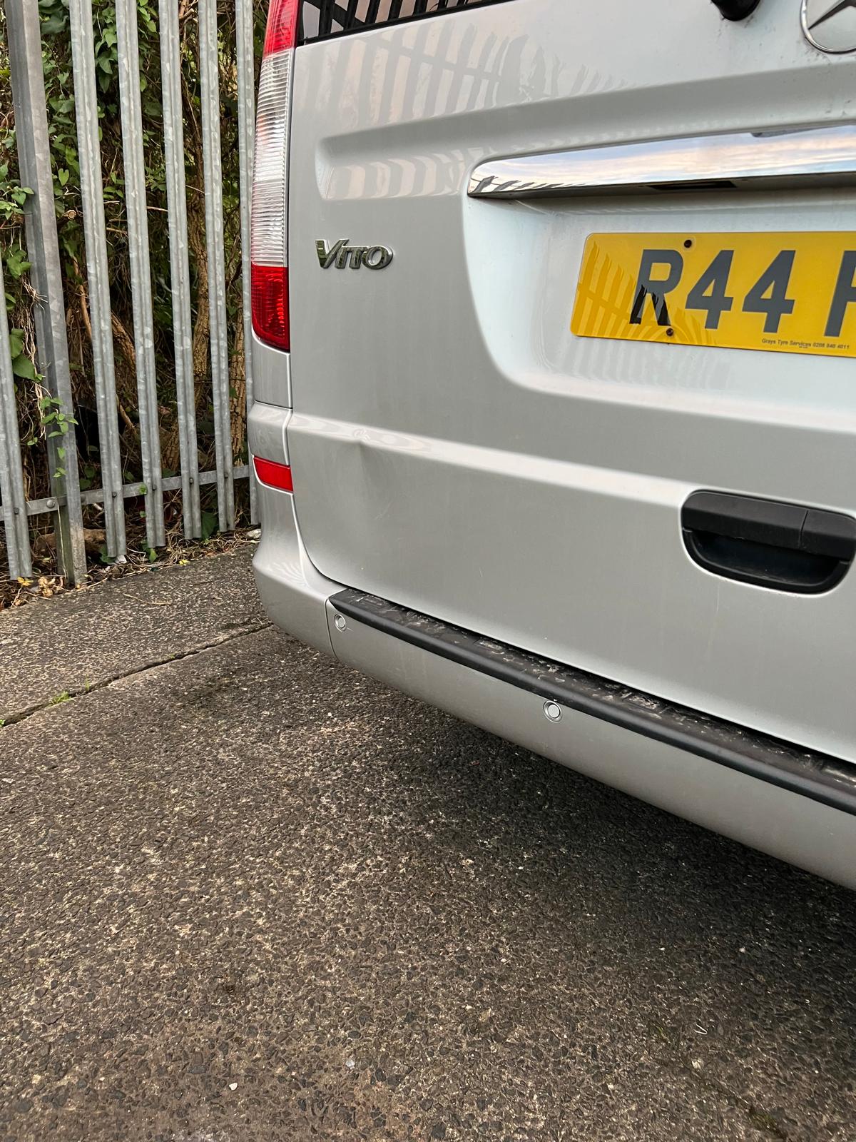An image of a dent on a grey car.